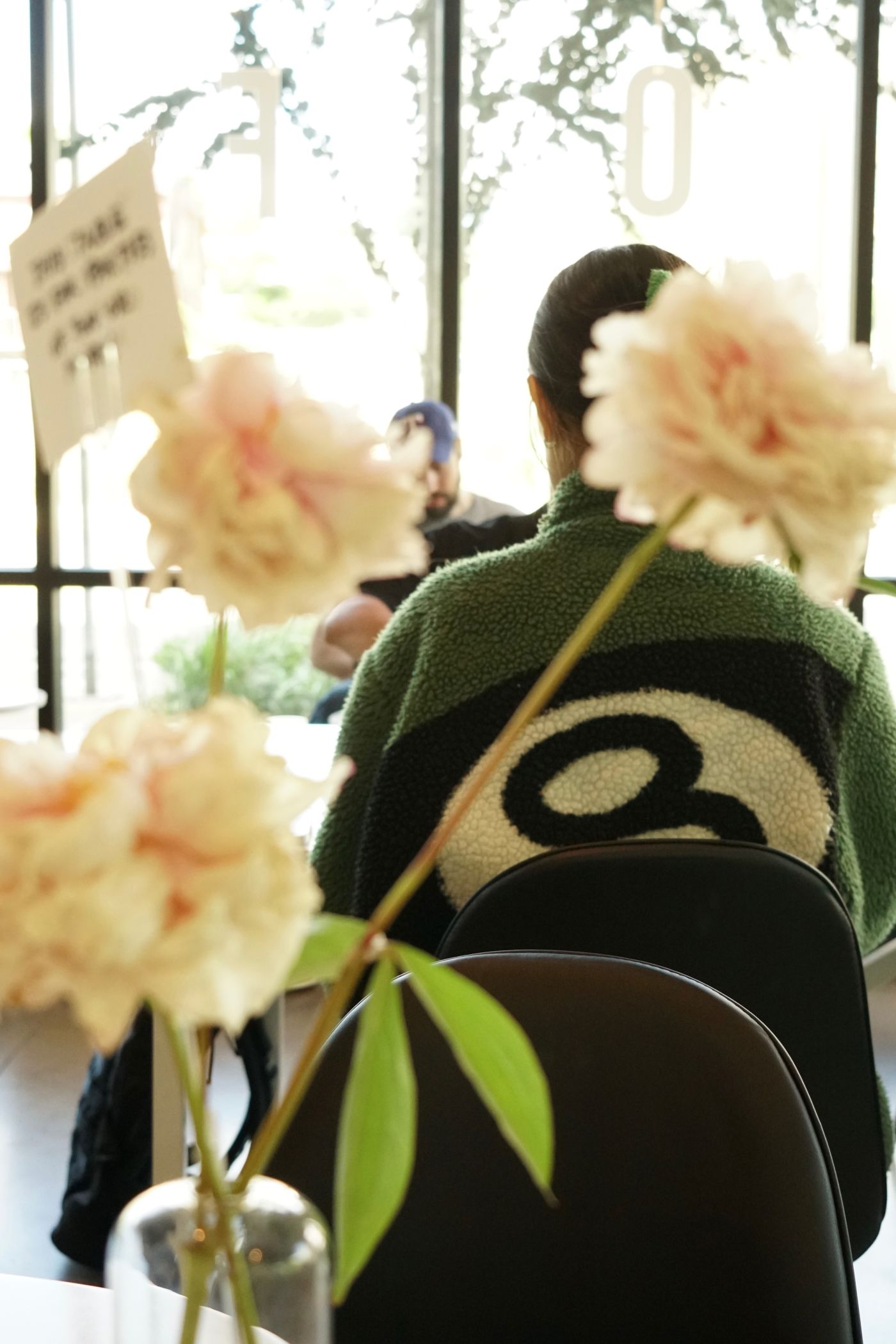 a café table with flowers in the foreground